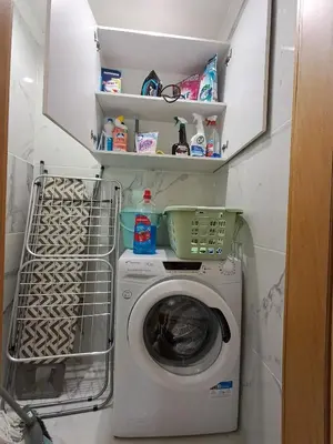 a washer and dryer in a small room at Cozy Airport Apartment in Machico