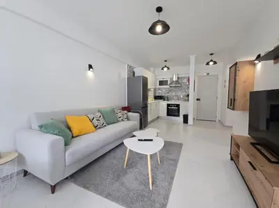 a living room with a couch and a table at Cozy Airport Apartment in Machico