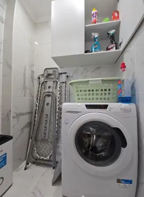 a washer and dryer in a small bathroom at Cozy Airport Apartment in Machico