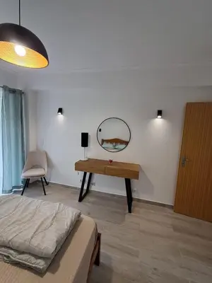 a bedroom with a bed and a mirror on the wall at Cozy Airport Apartment in Machico
