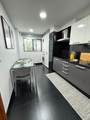 a kitchen with a table and a dining room at Ocean View Oasis Funchal with Parking in Funchal