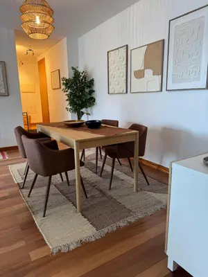 a dining room with a wooden table and chairs at Ocean View Oasis Funchal with Parking in Funchal