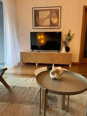 a living room with a tv and a table at Ocean View Oasis Funchal with Parking in Funchal
