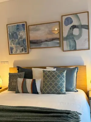 a bedroom with a bed with three pictures on the wall at Ocean View Oasis Funchal with Parking in Funchal