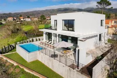an aerial view of a house with a swimming pool at OurMadeira - Casa Laranja in Prazeres