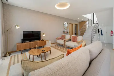 a living room with a couch and a television at OurMadeira - Casa Laranja in Prazeres