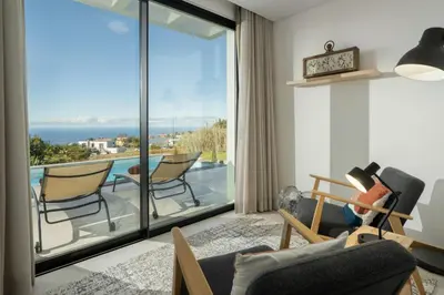 a living room with a view of the ocean at OurMadeira - Casa Laranja in Prazeres