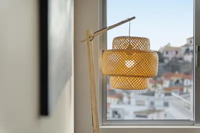 a lamp in a window with a view of a city at Little Paradise - Funchal in Funchal