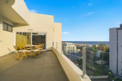 a balcony with a table and chairs on a building at Little Paradise - Funchal in Funchal