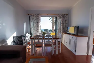 a kitchen and dining room with a table and chairs at Apartamentos Amarelo in Caniçal
