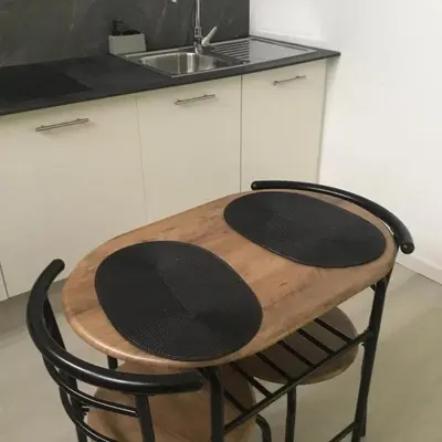a wooden table in a kitchen with a sink at White Studio in Câmara de Lobos