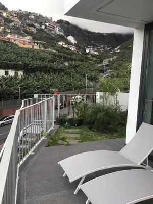 a balcony with a view of a city at White Studio in Câmara de Lobos