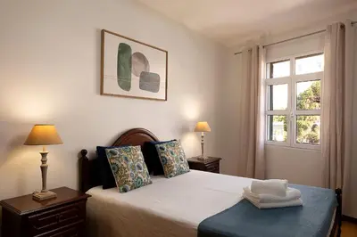 a bedroom with a bed and a window at Solful at the Nomads Village Ponta do Sol in Ponta do Sol