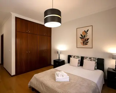 a bedroom with a bed with two towels on it at Solful at the Nomads Village Ponta do Sol in Ponta do Sol