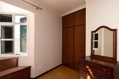 a room with a mirror and a dresser and a window at Solful at the Nomads Village Ponta do Sol in Ponta do Sol