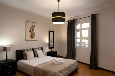 a bedroom with a bed and a window at Solful at the Nomads Village Ponta do Sol in Ponta do Sol