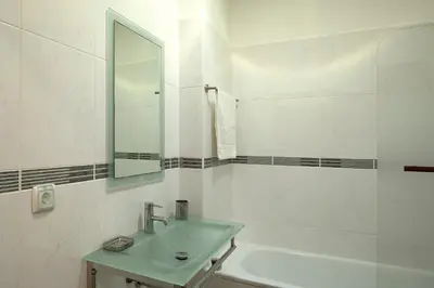 a white bathroom with a sink and a mirror at Solful at the Nomads Village Ponta do Sol in Ponta do Sol