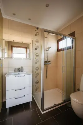 a bathroom with a shower and a sink and a mirror at New Quinta Aurora by Your Madeira Rentals in Estreito da Calheta