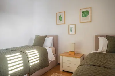 a kitchen and living room with a table and chairs at New Quinta Aurora by Your Madeira Rentals in Estreito da Calheta