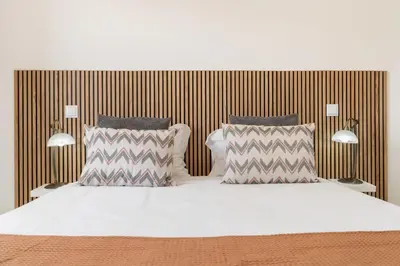 a bedroom with a bed with two pillows at Central Park Caniço Central Modern & Cozy in Santa Cruz