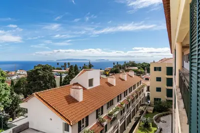 a view of the ocean from a building at Central Park Caniço Central Modern & Cozy in Santa Cruz