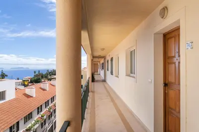 a balcony of a building with a view of the ocean at Central Park Caniço Central Modern & Cozy in Santa Cruz