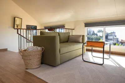 a living room with a couch and a table at Romantic Seaview Wine House in Madeira in Ponta do Sol