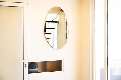 a mirror on a wall next to a door at Romantic Seaview Wine House in Madeira in Ponta do Sol