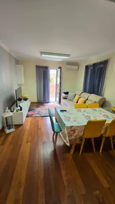 a living room with a couch and a table and chairs at Jardim do Sol in Nogueira