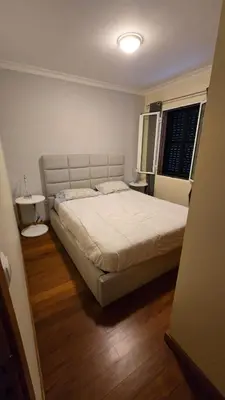 a bedroom with a large bed and a window at Jardim do Sol in Nogueira