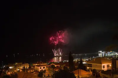 a firework display in the sky over a city at night at Casa da Badé in Funchal