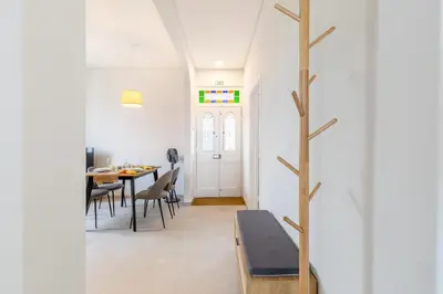 a dining room with a table and a tree at Casa da Badé in Funchal