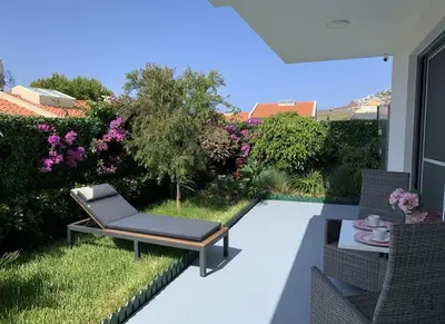 a garden with a pond and some plants at VILLA HELENA Pearl Apartment in Caniço