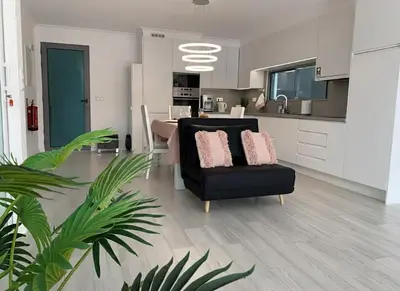 a living room with a couch and a television at VILLA HELENA Pearl Apartment in Caniço