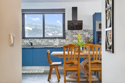 an overhead view of a swimming pool with an umbrella at Sea view flat in Casa Teixeira Calheta Madeira in Estreito da Calheta