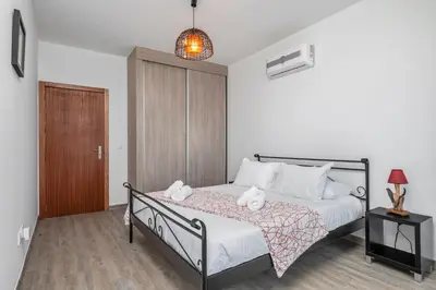 a bedroom with a bed with two stuffed animals on it at Sea view flat in Casa Teixeira Calheta Madeira in Estreito da Calheta