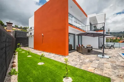 a modern house with a glass facade at Sea view flat in Casa Teixeira Calheta Madeira in Estreito da Calheta