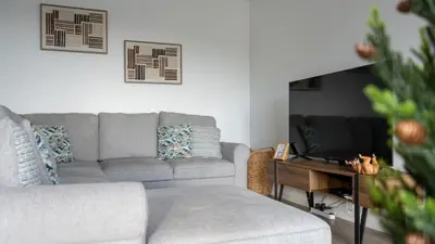 a living room with a couch and a television at Garachico Vista by LovelyStay in Estreito de Câmara de Lobos
