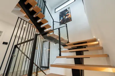 a staircase in a house with wood and metal railings at Garachico Vista by LovelyStay in Estreito de Câmara de Lobos