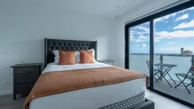 a bedroom with a large bed and a balcony at Garachico Vista by LovelyStay in Estreito de Câmara de Lobos