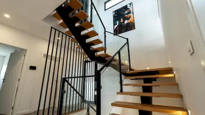 a spiral staircase in a home with white walls at Garachico Vista by LovelyStay in Estreito de Câmara de Lobos