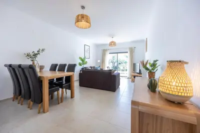 a dining room and living room with a table and chairs at Briso do Mós in Lagos
