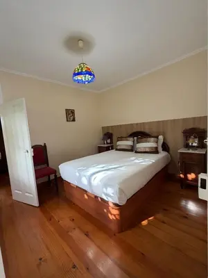 a bedroom with a large bed and a blue light at Casa da Cruz in Ponta do Sol
