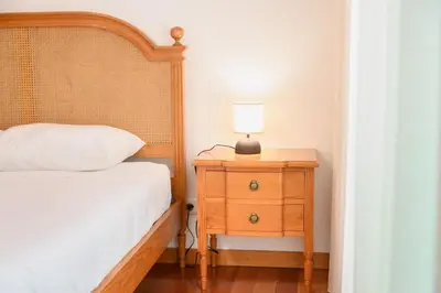 a bedroom with a bed and a nightstand with a lamp at Esmael Apartment 2 by Mth in Funchal