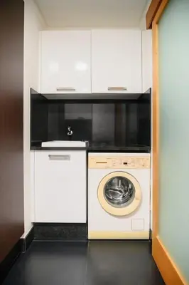 a kitchen with a washing machine and a microwave at Esmael Apartment 2 by Mth in Funchal