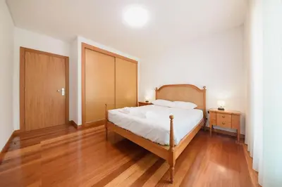 a bedroom with a bed and a wooden floor at Esmael Apartment 2 by Mth in Funchal