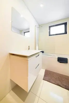a bathroom with a sink and a mirror and a tub at Esmael Apartment 2 by Mth in Funchal