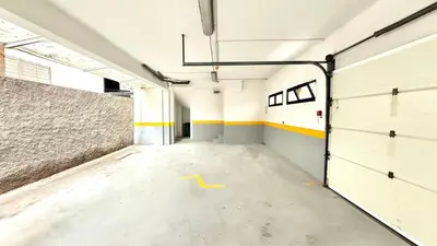 an empty garage with a yellow arrow on the floor at C Center Apartment in Funchal