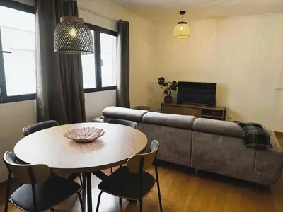 a living room with a table and a couch at C Center Apartment in Funchal