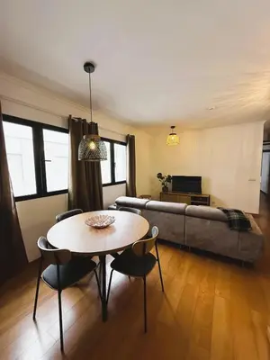 a living room with a table and a couch at C Center Apartment in Funchal